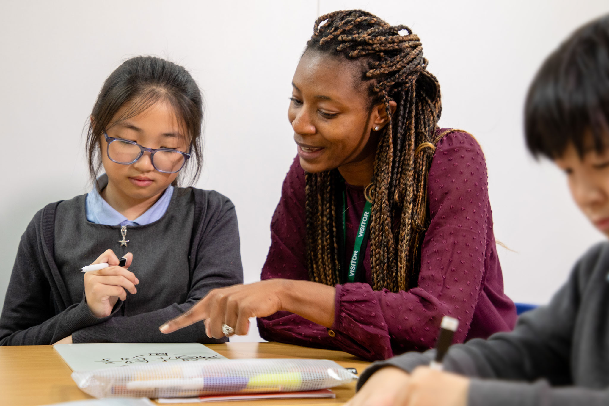 A teacher guiding a pupil through an exercise